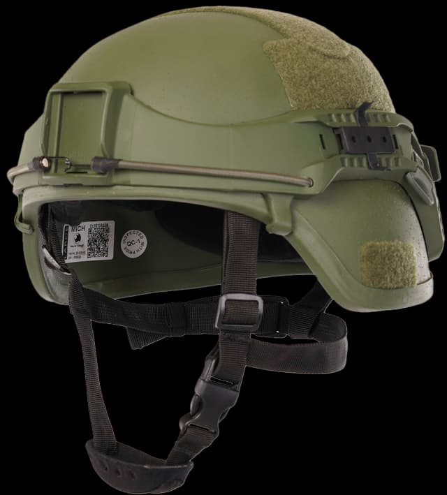 Side view of green boltless helmet with chin straps, Velcro patches, cable routing, and interior label visible.