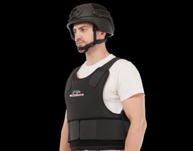 Man wearing Hard Shell Endorser Vest and tactical helmet for advanced ballistic protection and security operations.