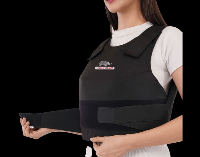Woman adjusting Hard Shell Vixen Vest, designed for female officers with lightweight, ergonomic ballistic protection.