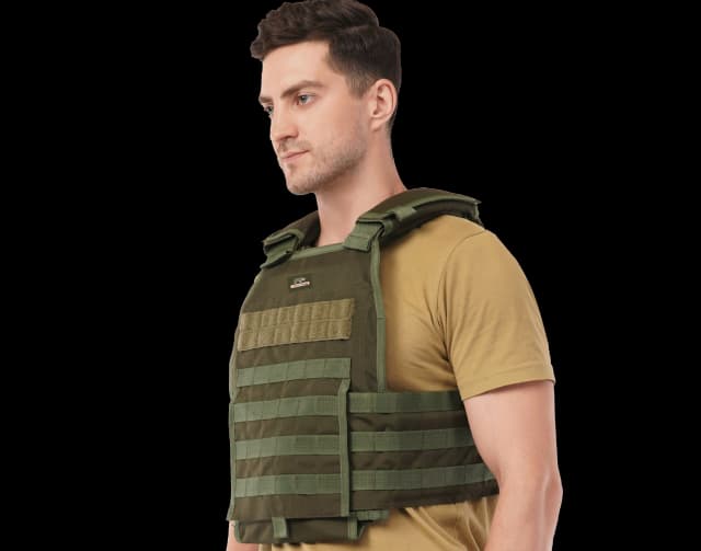 Man wearing Hard Shell Plate Carrier Vest - Slick II in olive green, showing side straps and lightweight design.