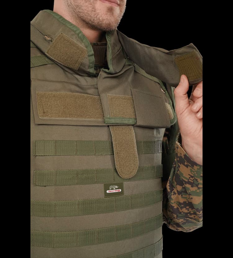 Close-up of Hard Shell olive green Rescuer Vest showing adjustable shoulder Velcro strap and MOLLE webbing for secure tactical gear attachment.