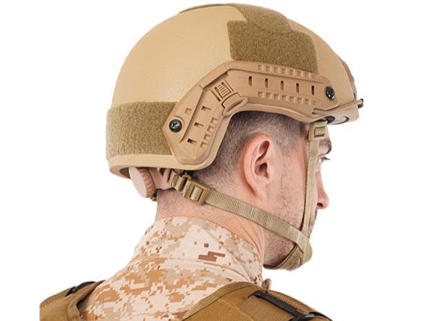 Side view of a RAPS ballistic helmet worn by a tactical operator with accessory rails and retention system.