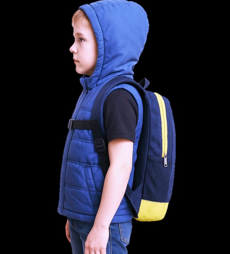 Side view of a young boy wearing a blue Steller Vest with hood and carrying a blue-and-yellow backpack.a
