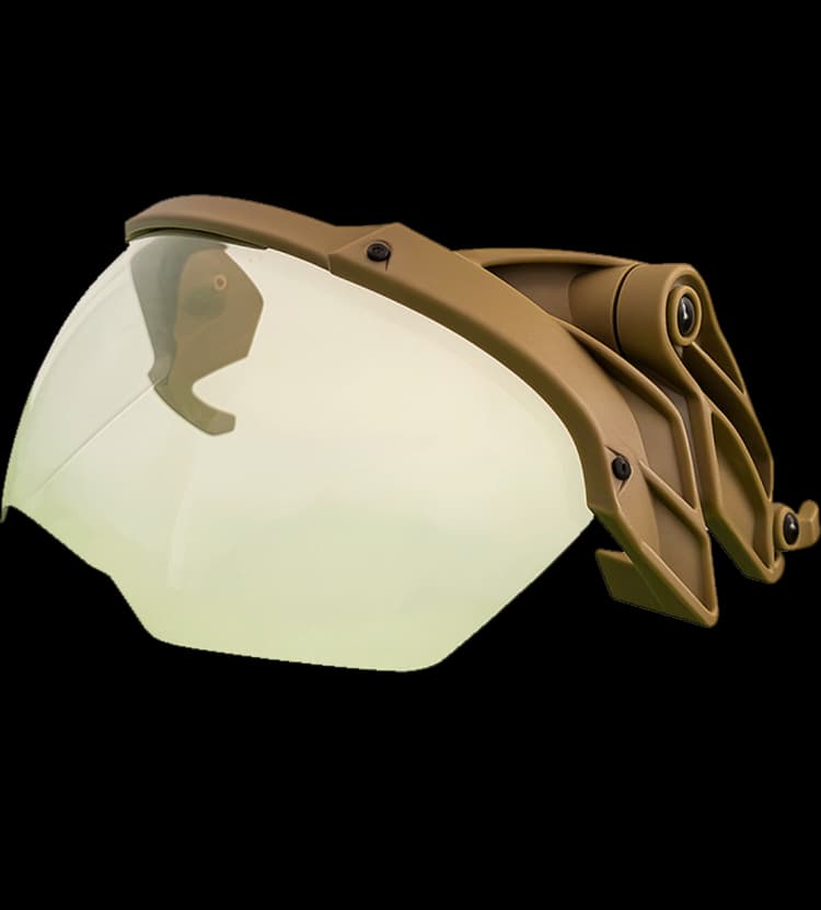 Side-angled view of a tan helmet fragment visor with a clear protective shield and hinge mount.