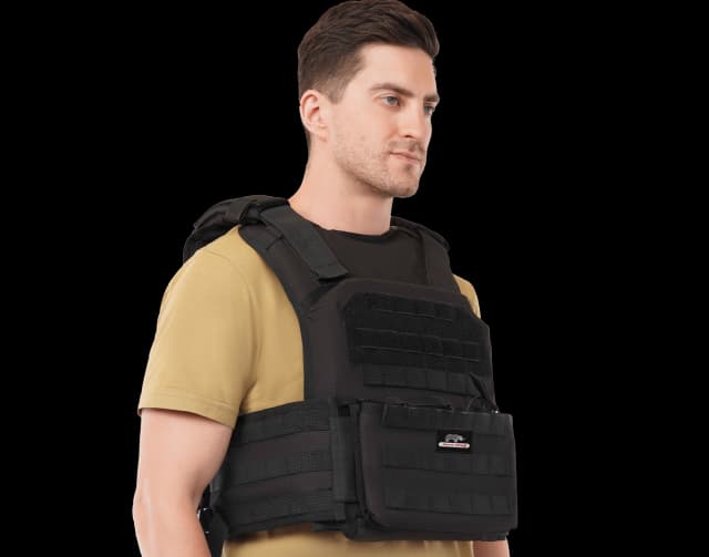 Man wearing Hard Shell Active Shooter Plate Carrier in black, showing side view with modular MOLLE system.