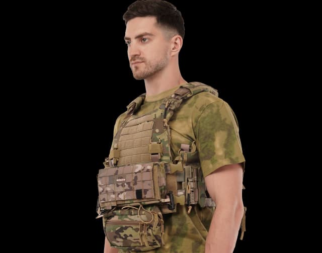 Man wearing Hard Shell Ranger Vest in camouflage pattern, showcasing tactical design and side pouches.