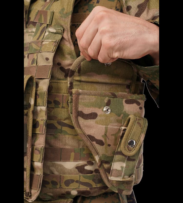 Close-up of Hard Shell camouflage Warrior Vest showing tactical side pouch with snap button closure for secure storage during field operations.