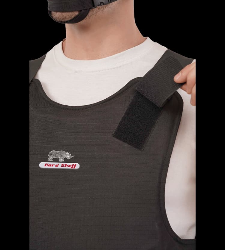 Close-up of Hard Shell Endorser Vest showing adjustable Velcro shoulder strap for secure and customized ballistic protection fit.