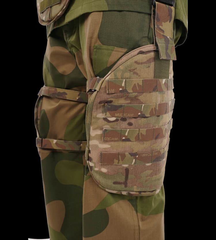 Close-up of Hard Shell Saviour Vest leg protection panel with adjustable straps and MOLLE webbing.