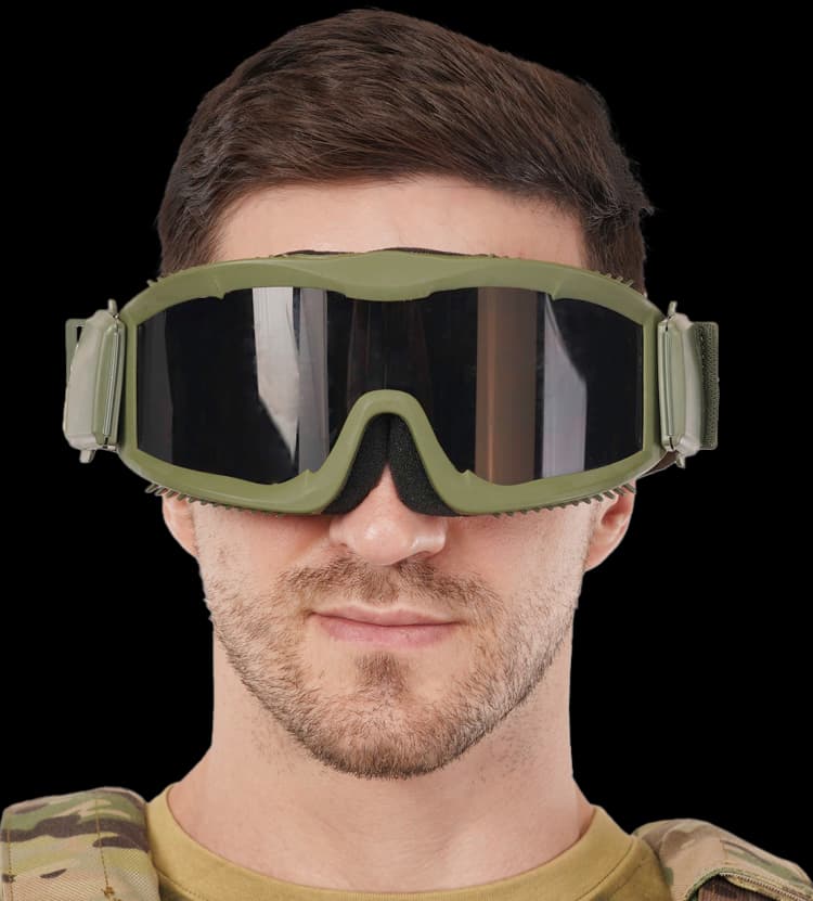 Person wearing green ballistic goggles with dark lenses in a front-facing view over tactical gear.