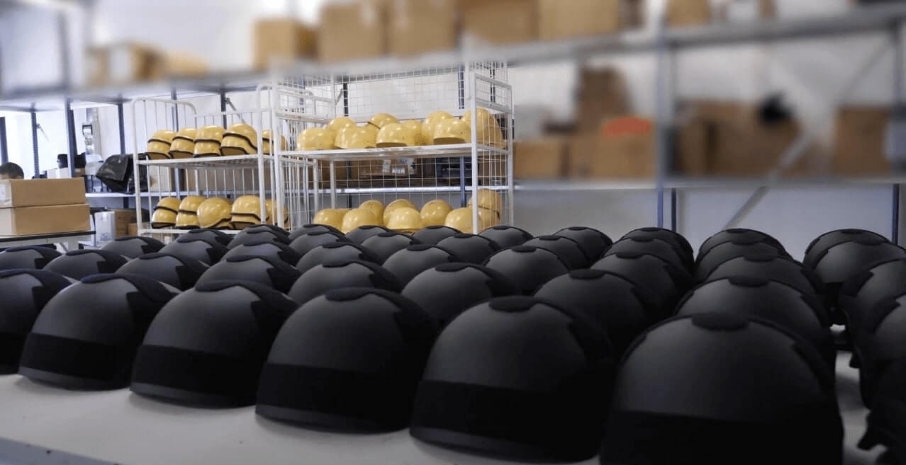 Black color ballistic helmets on table ready for final inspection